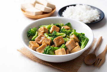 Stir fried tofu and broccoli with soy sauce eating with cooked rice, Asian vegan food