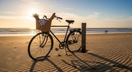 Fototapeta premium Vintage bike with basket on beach at sunset