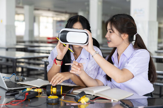 Students teen in uniform learning STEM with VR headset technology at school campus - Powered by Adobe