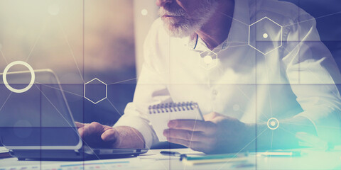 Senior businessman working on laptop, light effect, light effect, overlayed with diagrams, geometric pattern