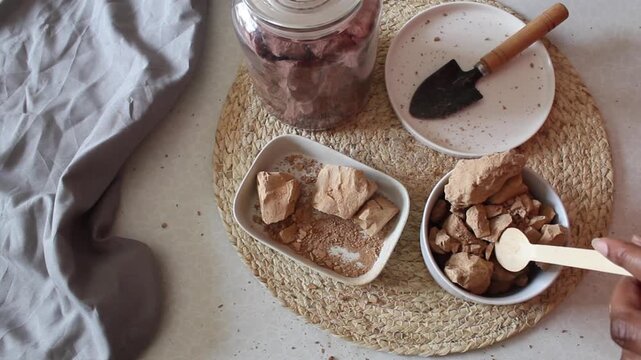 Brown clay stone in white plates flat lay
