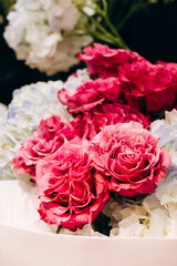 Fresh pink roses bouquet in a flower shop window, perfect for holidays.