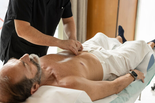 Acupuncturist performing acupuncture treatment for relaxation and pain relief