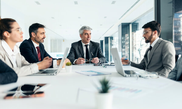 Business team brainstorming in executive office meeting