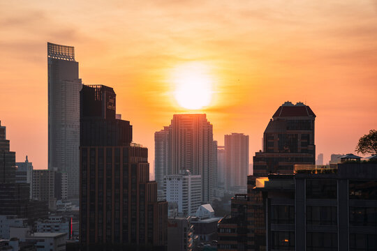 Bangkok rooftop cityscape at sunset with skyline and tall buildings