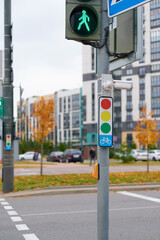 urban traffic scene with green pedestrian light signal and modern cityscape background showcasing intersection safety. highlighting urban planning and transportation dynamics