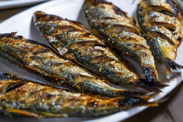 roasted gizzard shads on a white dish