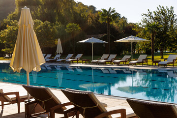 Swimming pool at tropical resort with palm trees