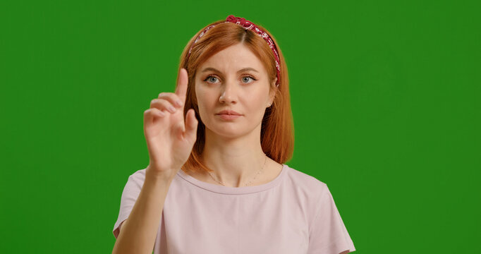 Woman using interactive touch screen with various gestures isolated green screen background. Casual woman using touch screen moving fingers. - Powered by Adobe