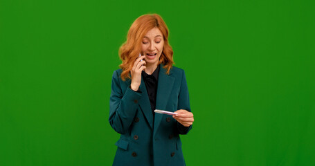 Female takes pregnancy test and makes call on smartphone entusiastic. Green screen background footage of pregnant woman receiving the news. Healthcare concept.