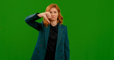 Thumbs down showed by woman and sad face of wrong sign of bad opinion. Upset unhappy young woman...