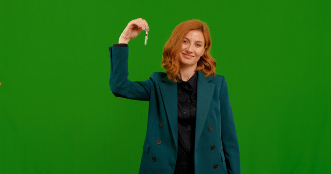 Excited woman first time homebuyer on green screen background. Female holding bunch of keys in her right hand green screen.