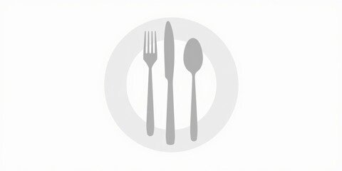 Elegant silverware set with fork knife and spoon artfully arranged on a clean white plate, perfect for culinary concepts