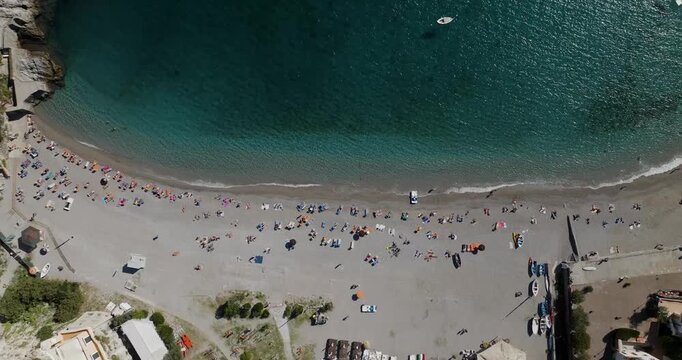 Aerial view of Erchie Beach showing the beachgoers enjoying the sun and sand with its turquoise waters, Erchie, Amalfi Coast, Italy.