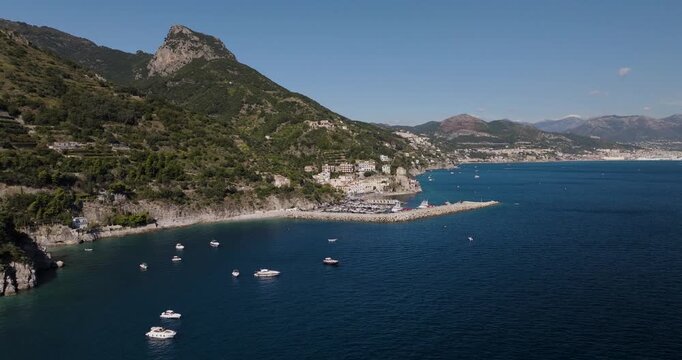 Aerial view of the picturesque Erchie coastline, where the deep blue sea contrasts with the green mountains and the white buildings, Erchie, Amalfi Coast, Italy.
