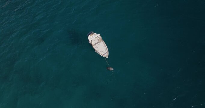 Aerial view of a lone boat floating serenely on the turquoise water, a contrast of colors against the Amalfi Coast, Erchie, Amalfi Coast, Italy.
