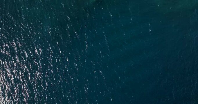 Aerial view of the dark blue open water, rippling slightly in the sunlight, showing the vastness of the sea, Erchie, Amalfi Coast, Italy.