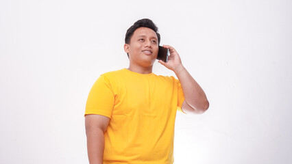 Fat Asian Man in Yellow T-Shirt Talking on Smartphone isolate on white background