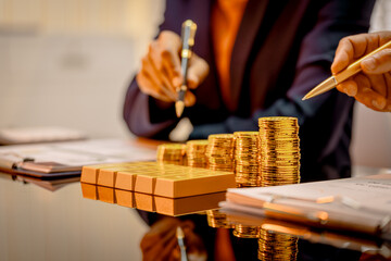 A suited Asian analyst confirms the tangible value of global gold holdings, carefully placing a...