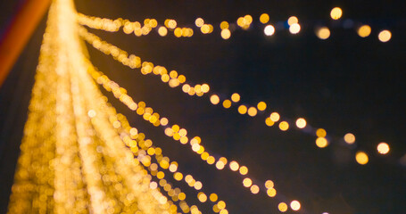 Christmas defocused candle lights on a bridge at the Christmas market. Blurred fairy lights. Out of...