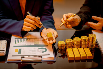 A suited Asian analyst confirms the tangible value of global gold holdings, carefully placing a...