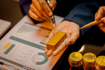 A suited Asian analyst confirms the tangible value of global gold holdings, carefully placing a...