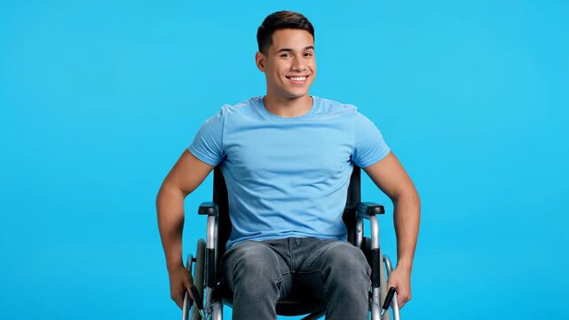 Cheerful young man with a physical disability in a wheelchair, radiating positivity and joy, captured in a studio setting with a vibrant blue background