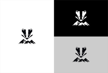 Badger's head with mountain range under it on white, black and gray