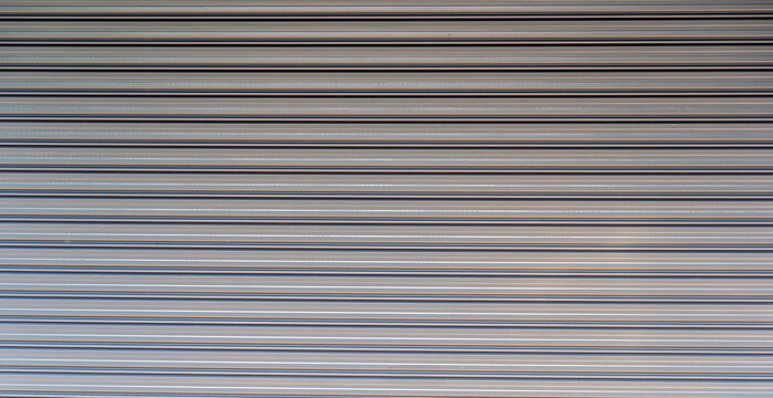 Background of corrugated metal sheet,white Slide door ,roller shutter texture, grills and metal doors security