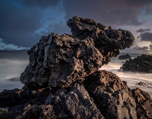 Dark Volcanic Rock Formation at Sunset