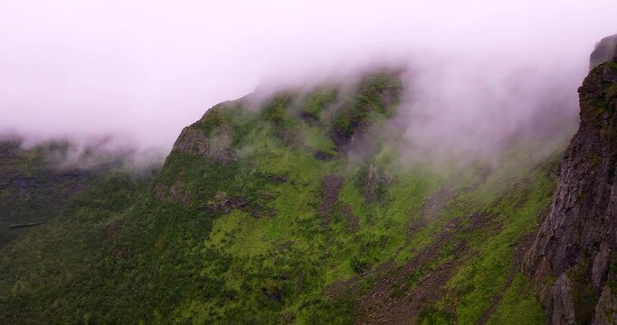 Mountains shrouded in mist and fog in Vester&aring;len, arctic landscape in northern Norway. Aerial drone