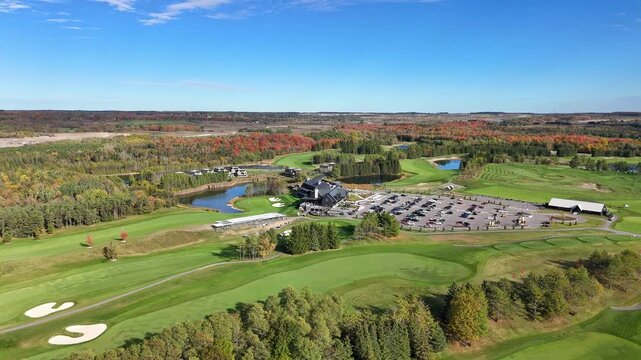 Stunning bird&rsquo;s eye aerial view of a golf resort surrounded by lush, mowed green lawns at TPC Toronto Osprey Valley Golf Course in Caledon, Ontario, Canada.