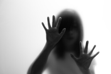 Silhouette of women behind frosted glass