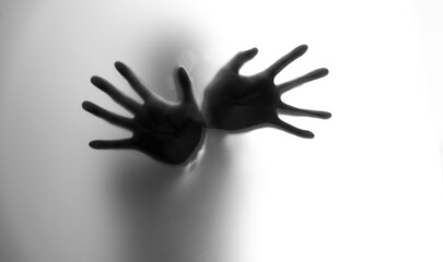 People hands behind frosted glass