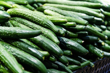 Pile of fresh cucumbers in market
