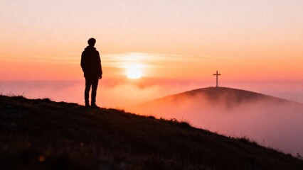 Man looking at sunrise and cross on hill, Catholic Easter