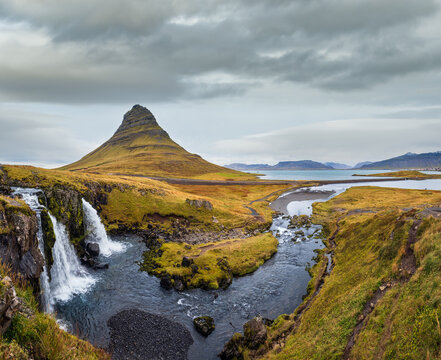 Famous picturesque Kirkjufell mountain and Kirkjufellsfoss waterfall next to Grundarfj&ouml;r&eth;ur at West Iceland autumn view.