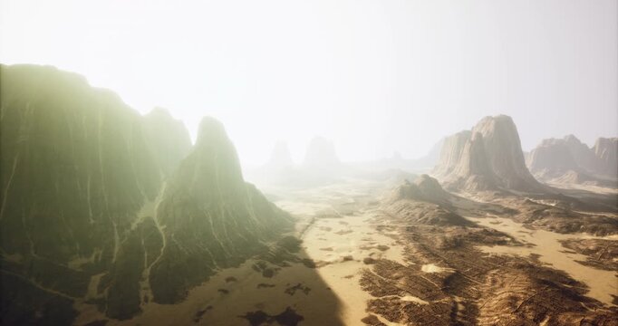 A breathtaking rocky terrain features towering formations under a warm, diffused sunlight. The vast desert stretches out with intricate patterns creating stunning natural beauty.