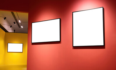 Blank art frames on yellow and red wall