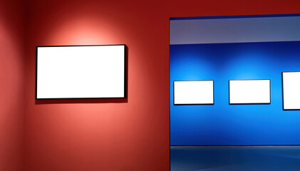 Blank art frames on red and blue wall