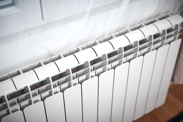 Obraz premium Heating radiator on a chilly winter day, energy and gas crisis, cold room, heating problems.