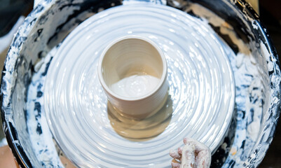 Artisan hands working on pottery wheel