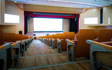 Empty auditorium with many chairs