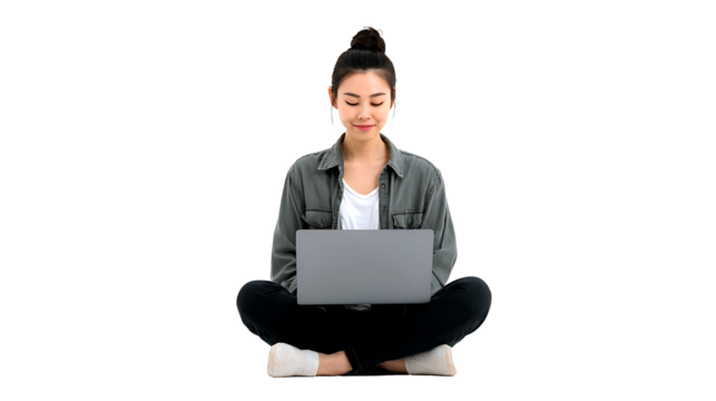 Asian girl sitting cross-legged using laptop, isolated on a white background
