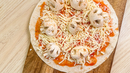 Uncooked pizza with mushroom caps, echoing Halloween's eerie spirits, invites savory alchemy and quirky culinary tales