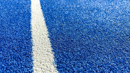 Cobalt racetrack's granular surface whispers tales of speed and dreams, echoing the adrenaline of Olympic hurdles and Blue Monday © fotoworld