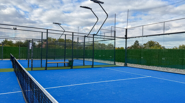 Outdoor padel court under a tapestry of clouds, echoing summer solstice festivities and International Day of Sport zest