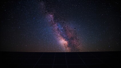 Solar panels under a starry sky with the Milky Way