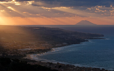 Sunset at the coast of Calabria with Stromboli in the background