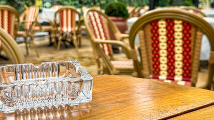 Intricate elegance of a sunlit cafe table with ornate wicker chairs; ideal for leisure tales or Cafe Terrace Night